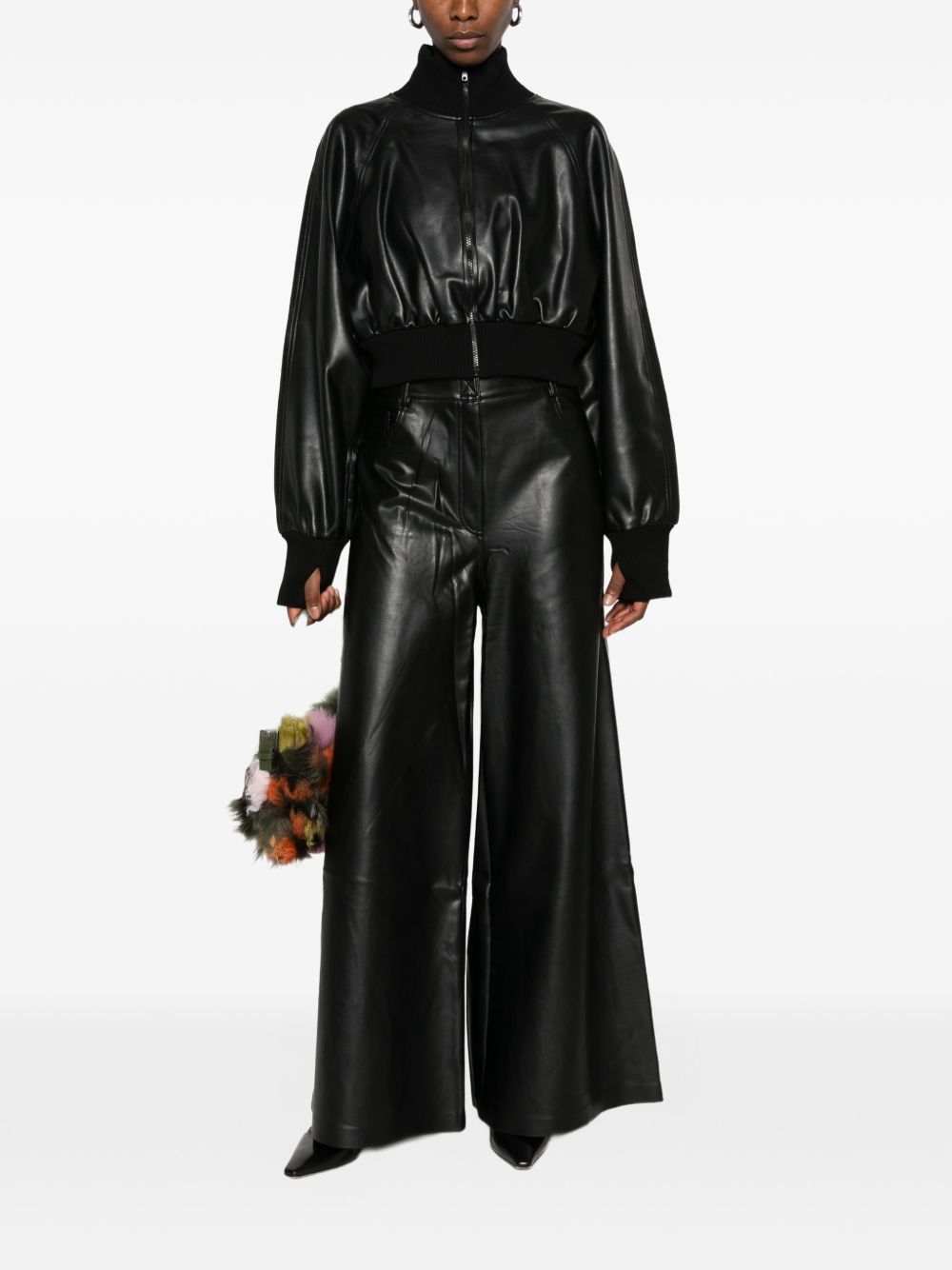 Norma Kamali black faux-leather wide-leg jeans styling detail