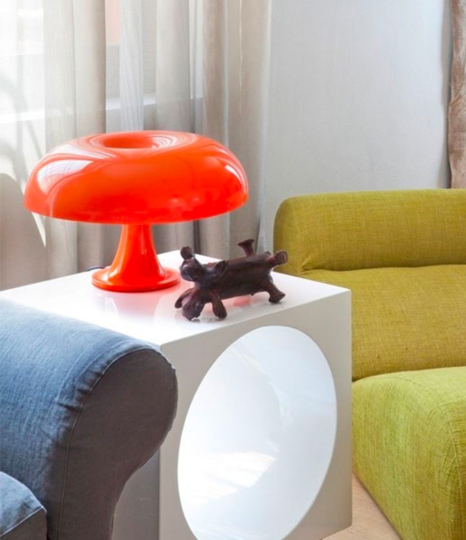 Artemide Nessino orange table lamp in an interior setting
