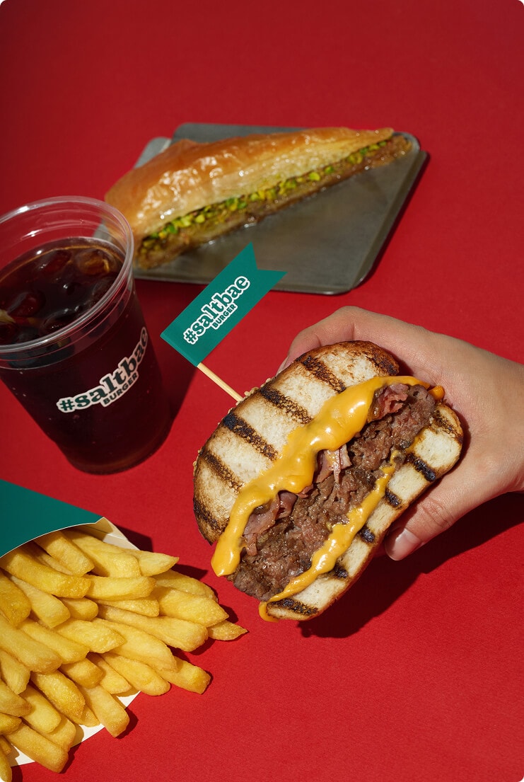 Official Saltbae Burger brand image with burger, fries and drink in red studio setup